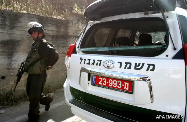 Israeli riot police get ready to arrest a Palestinian man in a car, whose rear window was smashed during clashes between Palestinian youth and the Israeli police in the east Jerusalem neighbourhood of Silwan on May 12, 2...