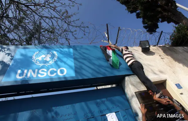 Palestinian protesters block the entrance to a UNESCO headquarters during a protest in Gaza City, to show solidarity with Palestinian prisoners held in Israeli jails, May 13, 2012. Hundreds of Palestinians on hunger stri...