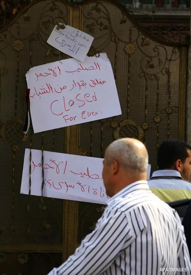 Palestinian men stand outside the headquarters of the International Committee of the Red Cross (ICRC) in Gaza as they forced the offices to close for two hours in solidarity with over 1,550 prisoners observing a hunger s...