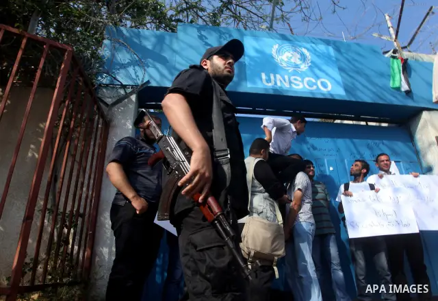 Palestinian men stand outside the headquarters of the International Committee of the Red Cross (ICRC) in Gaza as they forced the offices to close for two hours in solidarity with over 1,550 prisoners observing a hunger s...