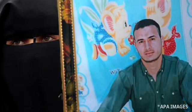 Palestinian women hold pictures of incarcerated relatives in a rally to show solidarity with prisoners held in Israeli jails, in Gaza City May 14, 2012. One in three of the 4,800 Palestinians serving time in Israeli jail...