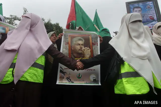 Palestinian women hold pictures of incarcerated relatives in a rally to show solidarity with prisoners held in Israeli jails, in Gaza City May 14, 2012. One in three of the 4,800 Palestinians serving time in Israeli jail...