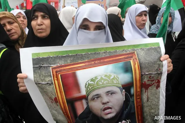 Palestinian women hold pictures of incarcerated relatives in a rally to show solidarity with prisoners held in Israeli jails, in Gaza City May 14, 2012. One in three of the 4,800 Palestinians serving time in Israeli jail...