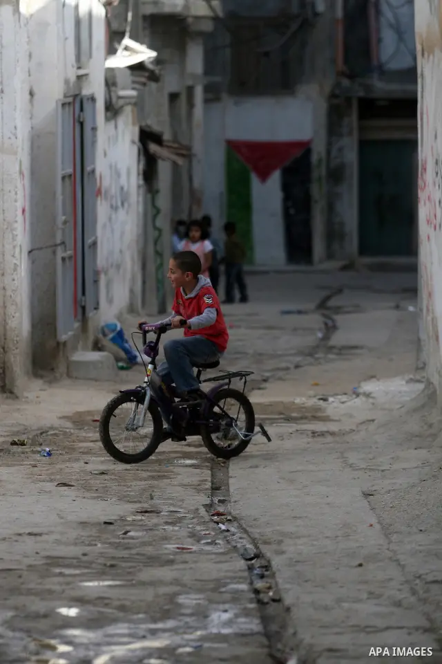Palestinian refugee children play outside their home, a day before Palestinians mark the 'Nakba' Day (Day of the catastrophe), in the Al amari refugee camp in the West Bank City of Ramallah on 14 May 2012. 'Nakba' Day fo...