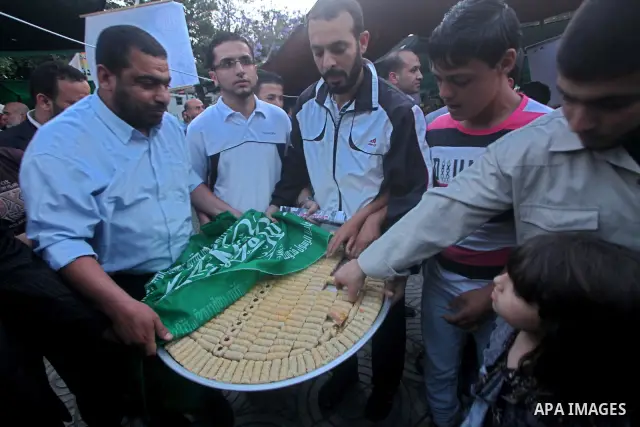Relatives of Palestinian prisoners held in Israeli jails celebrate after the signing of a deal to end the prisoners hunger strike in Gaza City on 14 May 2012. Israel and Palestinian signed an agreement 14 May ending a ma...