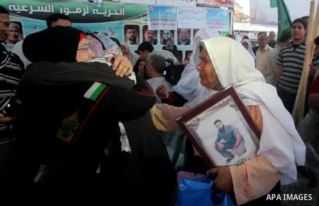 Relatives of Palestinian prisoners held in Israeli jails celebrate after the signing of a deal to end the prisoners hunger strike in Gaza City on 14 May 2012. Israel and Palestinian signed an agreement 14 May ending a ma...
