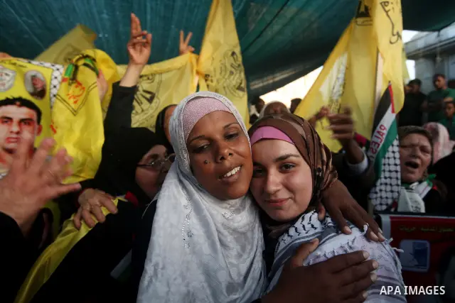 Relatives of Palestinian prisoners held in Israeli jails celebrate after the signing of a deal to end the prisoners hunger strike in Gaza City on 14 May 2012. Israel and Palestinian signed an agreement 14 May ending a ma...