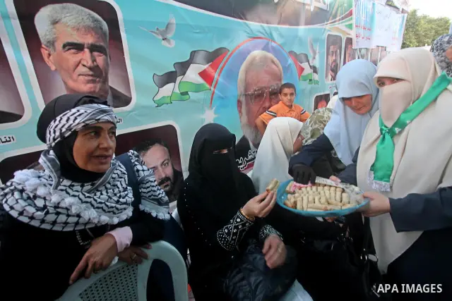 Relatives of Palestinian prisoners held in Israeli jails celebrate after the signing of a deal to end the prisoners hunger strike in Gaza City on 14 May 2012. Israel and Palestinian signed an agreement 14 May ending a ma...
