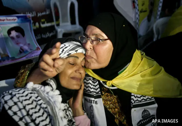 Relatives of Palestinian prisoners held in Israeli jails celebrate after the signing of a deal to end the prisoners hunger strike in Gaza City on 14 May 2012. Israel and Palestinian signed an agreement 14 May ending a ma...