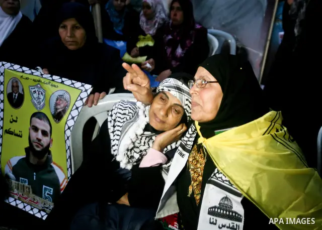 Relatives of Palestinian prisoners held in Israeli jails celebrate after the signing of a deal to end the prisoners hunger strike in Gaza City on 14 May 2012. Israel and Palestinian signed an agreement 14 May ending a ma...