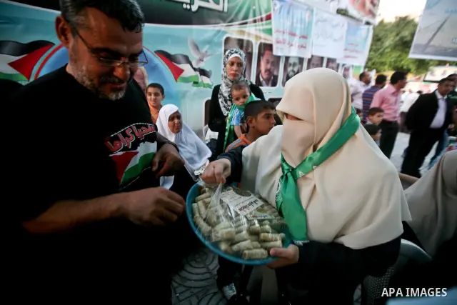 Relatives of Palestinian prisoners held in Israeli jails celebrate after the signing of a deal to end the prisoners hunger strike in Gaza City on 14 May 2012. Israel and Palestinian signed an agreement 14 May ending a ma...