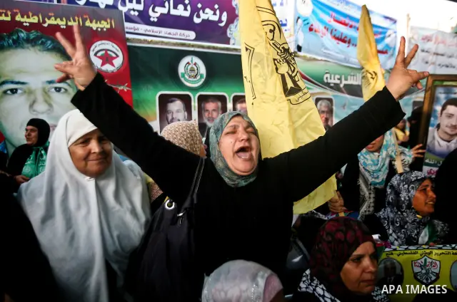 Relatives of Palestinian prisoners held in Israeli jails celebrate after the signing of a deal to end the prisoners hunger strike in Gaza City on 14 May 2012. Israel and Palestinian signed an agreement 14 May ending a ma...