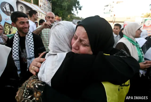 Relatives of Palestinian prisoners held in Israeli jails celebrate after the signing of a deal to end the prisoners hunger strike in Gaza City on 14 May 2012. Israel and Palestinian signed an agreement 14 May ending a ma...