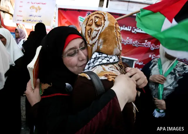 Relatives of Palestinian prisoners held in Israeli jails celebrate after the signing of a deal to end the prisoners hunger strike in Gaza City on 14 May 2012. Israel and Palestinian signed an agreement 14 May ending a ma...