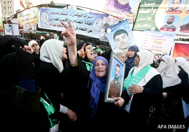 Relatives of Palestinian prisoners held in Israeli jails celebrate after the signing of a deal to end the prisoners hunger strike in Gaza City on 14 May 2012. Israel and Palestinian signed an agreement 14 May ending a ma...
