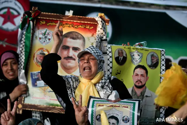 Relatives of Palestinian prisoners held in Israeli jails celebrate after the signing of a deal to end the prisoners hunger strike in Gaza City on 14 May 2012. Israel and Palestinian signed an agreement 14 May ending a ma...