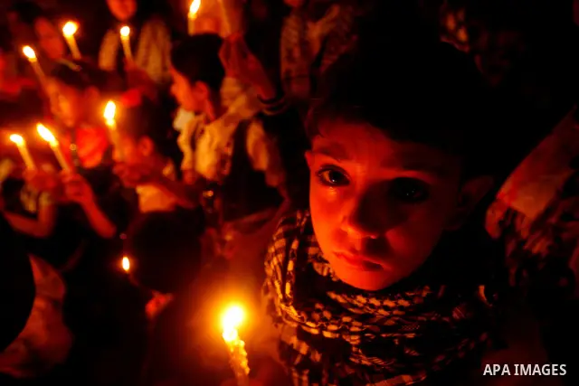 Palestinian children hold candles during a rally in Khan Younis in the southern Gaza Strip, ahead of Nakba May 14, 2012. On May 15 Palestinians will mark Nakba, or catastrophe, of Israel's founding in a 1948 war, when hu...