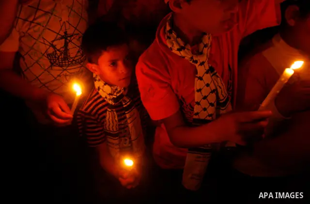 Palestinian children hold candles during a rally in Khan Younis in the southern Gaza Strip, ahead of Nakba May 14, 2012. On May 15 Palestinians will mark Nakba, or catastrophe, of Israel's founding in a 1948 war, when hu...