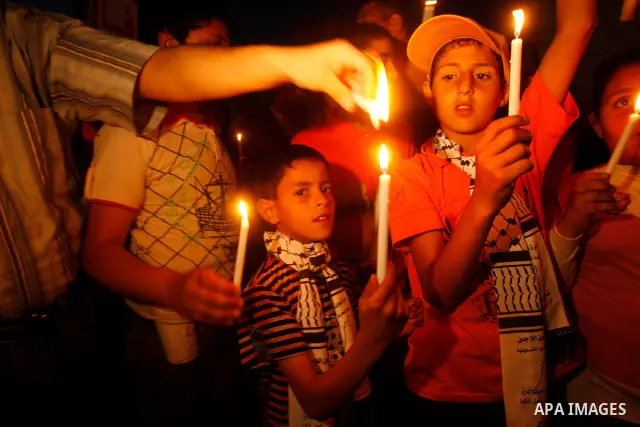 Palestinian children hold candles during a rally in Khan Younis in the southern Gaza Strip, ahead of Nakba May 14, 2012. On May 15 Palestinians will mark Nakba, or catastrophe, of Israel's founding in a 1948 war, when hu...