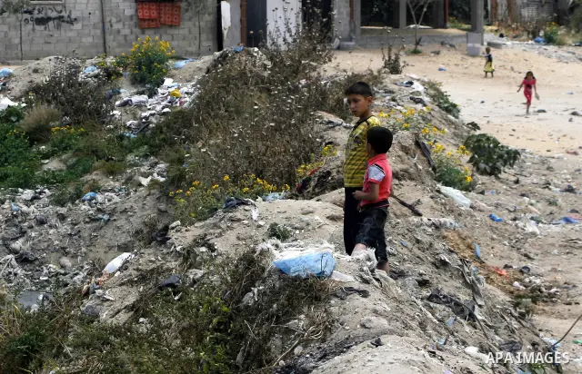 Palestinian boys stand among the garbage in the Rafah Refugee Camp in the southern Gaza Strip, ahead of Nakba Day. on May 15, 2012. 'Nakba' Day for the Palestinians is an annual day of commemoration of the displacement t...