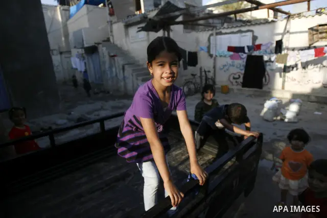 Palestinian children play outside their home in the Rafah refugee camp in the southern Gaza Strip on May 13, 2012. 'Nakba' Day for the Palestinians is an annual day of commemoration of the displacement that followed the...