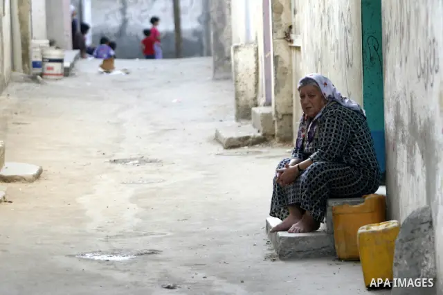 A Palestinian woman sits outside their home in the Rafah refugee camp in the southern Gaza Strip on May 13, 2012. 'Nakba' Day for the Palestinians is an annual day of commemoration of the displacement that followed the I...