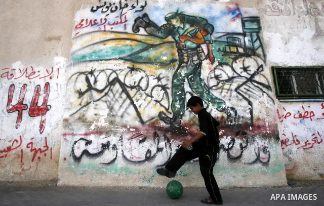 A Palestinian child plays outside their home in the Rafah refugee camp in the southern Gaza Strip on May 13, 2012. 'Nakba' Day for the Palestinians is an annual day of commemoration of the displacement that followed the...