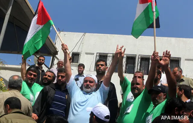 The head of Gaza's Hamas government, Ismail Haniya (blue polo shirt), takes part in a marathonin Gaza on May 15, 2012. 'Nakba' Day for the Palestinians is an annual day of commemoration of the displacement that followed...