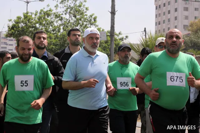 The head of Gaza's Hamas government, Ismail Haniya (blue polo shirt), takes part in a marathonin Gaza on May 15, 2012. 'Nakba' Day for the Palestinians is an annual day of commemoration of the displacement that followed...