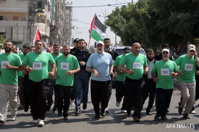 The head of Gaza's Hamas government, Ismail Haniya (blue polo shirt), takes part in a marathonin Gaza on May 15, 2012. 'Nakba' Day for the Palestinians is an annual day of commemoration of the displacement that followed...
