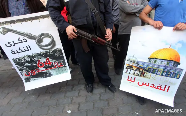 Palestinian protesters hold portraits, during a marathonin, participate the head of Gaza's Hamas government, Ismail Haniya Gaza on May 15, 2012. 'Nakba' Day for the Palestinians is an annual day of commemoration of the d...