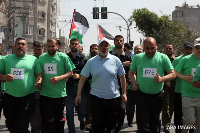 The head of Gaza's Hamas government, Ismail Haniya (blue polo shirt), takes part in a marathonin Gaza on May 15, 2012. 'Nakba' Day for the Palestinians is an annual day of commemoration of the displacement that followed...