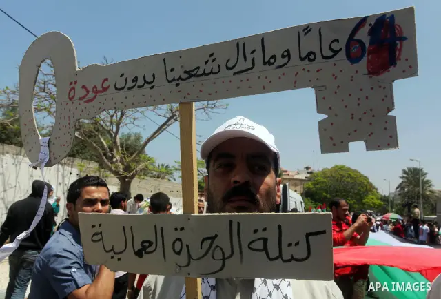 Palestinians hold keys symbolizing keys to houses left by Palestinians in 1948. Palestinians take part in a mass demonstration in front of UN headquarters of UNESCO marking Nakba when Palestinians were forced to leave th...