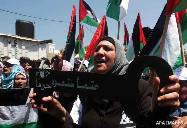 Palestinians hold keys symbolizing keys to houses left by Palestinians in 1948. Palestinians take part in a mass demonstration in front of UN headquarters of UNESCO marking Nakba when Palestinians were forced to leave th...