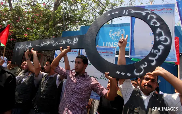 Palestinians hold keys symbolizing keys to houses left by Palestinians in 1948. Palestinians take part in a mass demonstration in front of UN headquarters of UNESCO marking Nakba when Palestinians were forced to leave th...