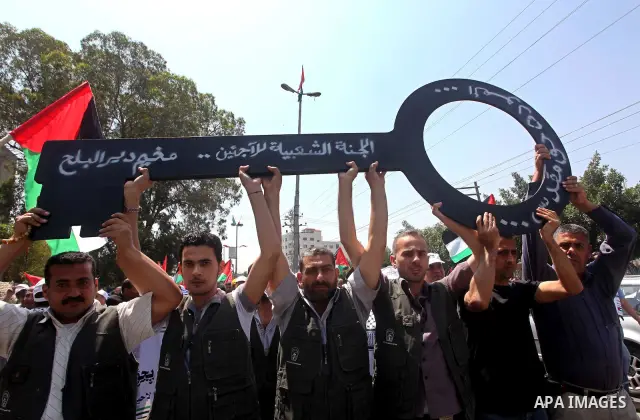 Palestinians hold keys symbolizing keys to houses left by Palestinians in 1948. Palestinians take part in a mass demonstration in front of UN headquarters of UNESCO marking Nakba when Palestinians were forced to leave th...