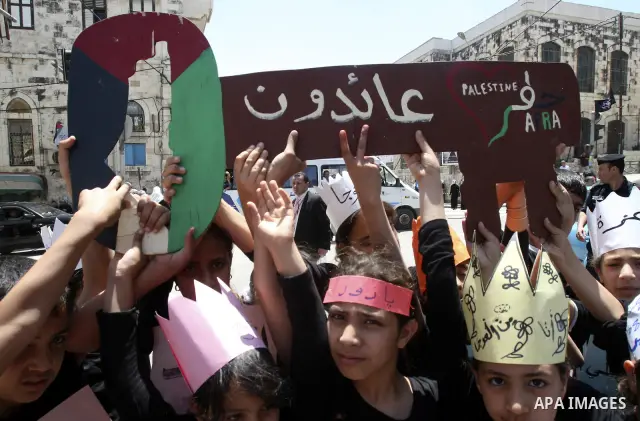 Palestinians participate in a rally marking the 64th anniversary of "Nakba", Arabic for catastrophe, the term used to mark the events leading to Israel's founding in 1948, in the West Bank city of Nablus, Tuesday, May 15...