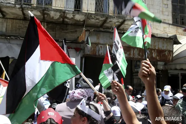 Palestinians participate in a rally marking the 64th anniversary of "Nakba", Arabic for catastrophe, the term used to mark the events leading to Israel's founding in 1948, in the West Bank city of Nablus, Tuesday, May 15...