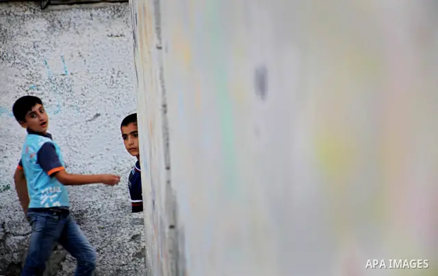 Palestinian children play in front of their homes in the Shati Palestinian refugee camp in Gaza City on May 15, 2012, as Palestinians and Arab-Israelis marked Nakba day, which commemorates the exodus of hundreds of thous...