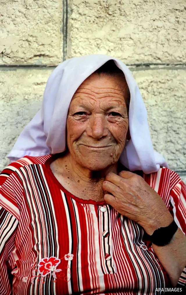 A Palestinian woman sits outside her home in the Shati Palestinian refugee camp in Gaza City on May 15, 2012, as Palestinians and Arab-Israelis marked Nakba day, which commemorates the exodus of hundreds of thousands of...