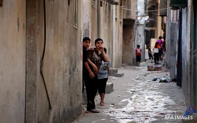 Palestinian children play in front of their homes in the Shati Palestinian refugee camp in Gaza City on May 15, 2012, as Palestinians and Arab-Israelis marked Nakba day, which commemorates the exodus of hundreds of thous...
