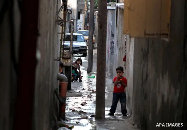 Palestinian children play in front of their homes in the Shati Palestinian refugee camp in Gaza City on May 15, 2012, as Palestinians and Arab-Israelis marked Nakba day, which commemorates the exodus of hundreds of thous...