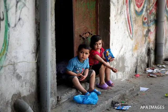Palestinian children play in front of their homes in the Shati Palestinian refugee camp in Gaza City on May 15, 2012, as Palestinians and Arab-Israelis marked Nakba day, which commemorates the exodus of hundreds of thous...