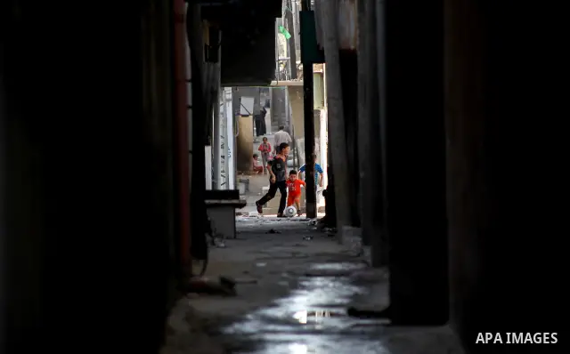 Palestinian children play in front of their homes in the Shati Palestinian refugee camp in Gaza City on May 15, 2012, as Palestinians and Arab-Israelis marked Nakba day, which commemorates the exodus of hundreds of thous...