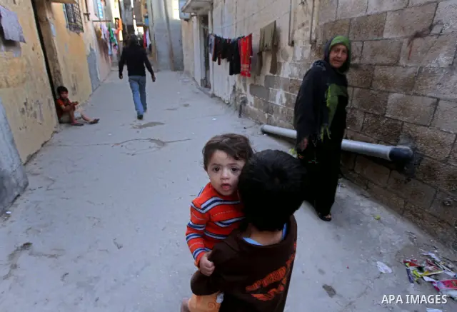 Palestinian children play in front of their homes in the Shati Palestinian refugee camp in Gaza City on May 15, 2012, as Palestinians and Arab-Israelis marked Nakba day, which commemorates the exodus of hundreds of thous...