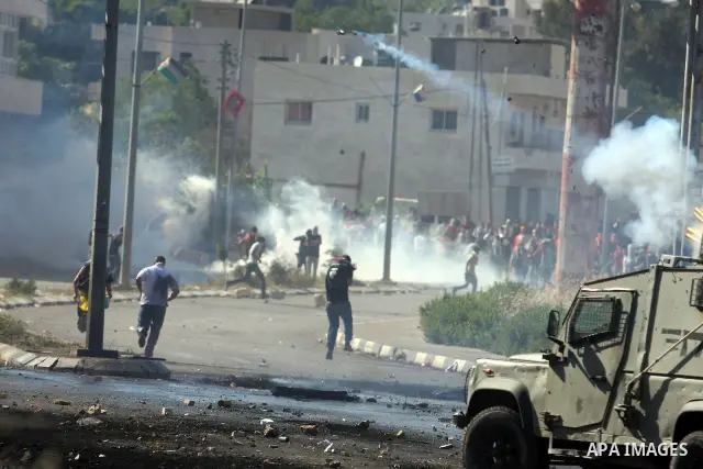 Palestinian protesters throw stones towards Israeli border police during clashes on Nakba Day near Ofer prison, near Ramallah, the West Bank, 15 May 2012. Thousands marched in the West Bank and Gaza Strip, commemorating...