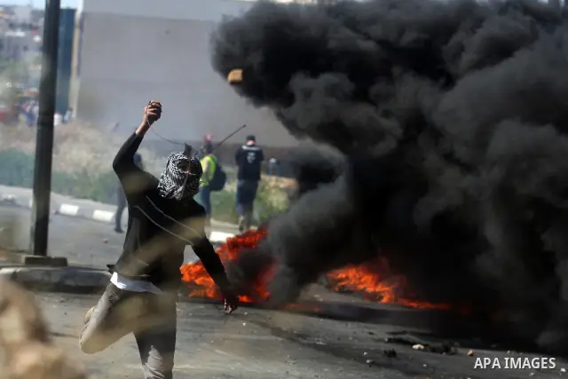 Palestinian protesters throw stones towards Israeli border police during clashes on Nakba Day near Ofer prison, near Ramallah, the West Bank, 15 May 2012. Thousands marched in the West Bank and Gaza Strip, commemorating...
