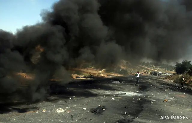Palestinian protesters throw stones towards Israeli border police during clashes on Nakba Day near Ofer prison, near Ramallah, the West Bank, 15 May 2012. Thousands marched in the West Bank and Gaza Strip, commemorating...