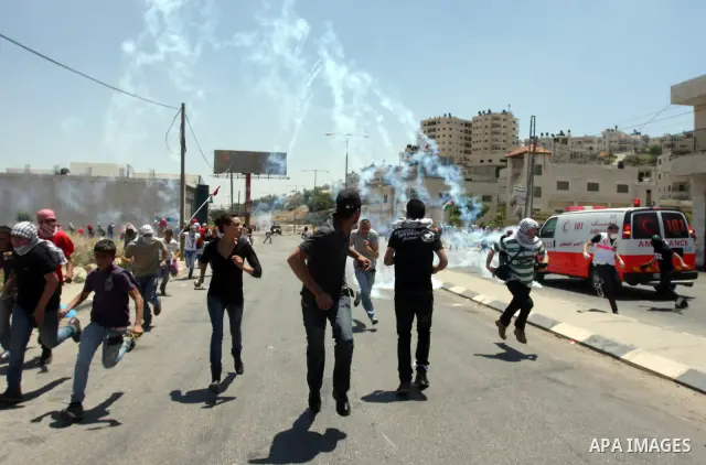 Palestinian protesters throw stones towards Israeli border police during clashes on Nakba Day near Ofer prison, near Ramallah, the West Bank, 15 May 2012. Thousands marched in the West Bank and Gaza Strip, commemorating...