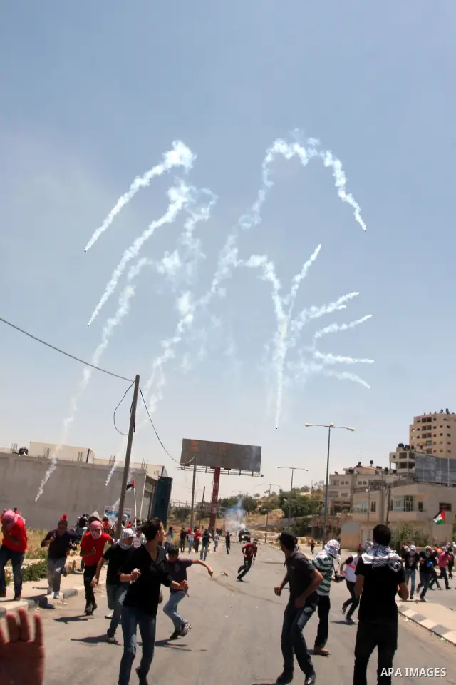 Palestinian protesters throw stones towards Israeli border police during clashes on Nakba Day near Ofer prison, near Ramallah, the West Bank, 15 May 2012. Thousands marched in the West Bank and Gaza Strip, commemorating...
